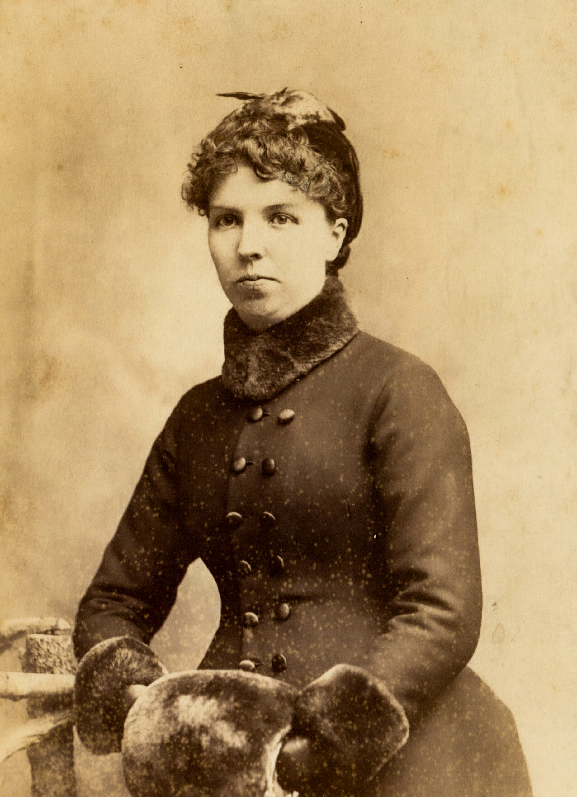 victorian-era-portrait-of-a-woman-in-winter-coat-with-fur-accessories-and-a-stylish-hat