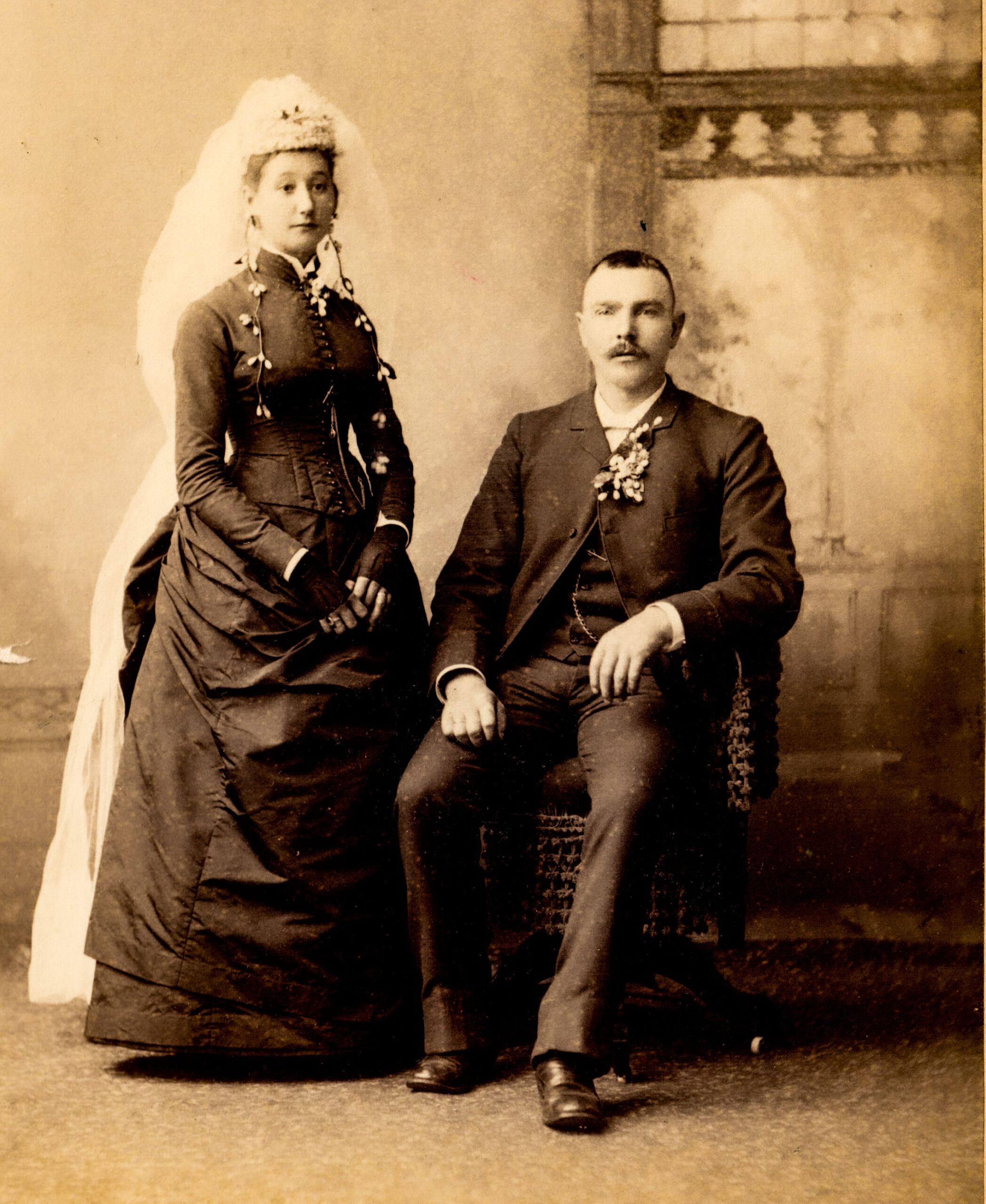 Victorian Wedding Portrait of a Bride in Elegant Gown and Groom Seated in Formal Suit artist reference photo