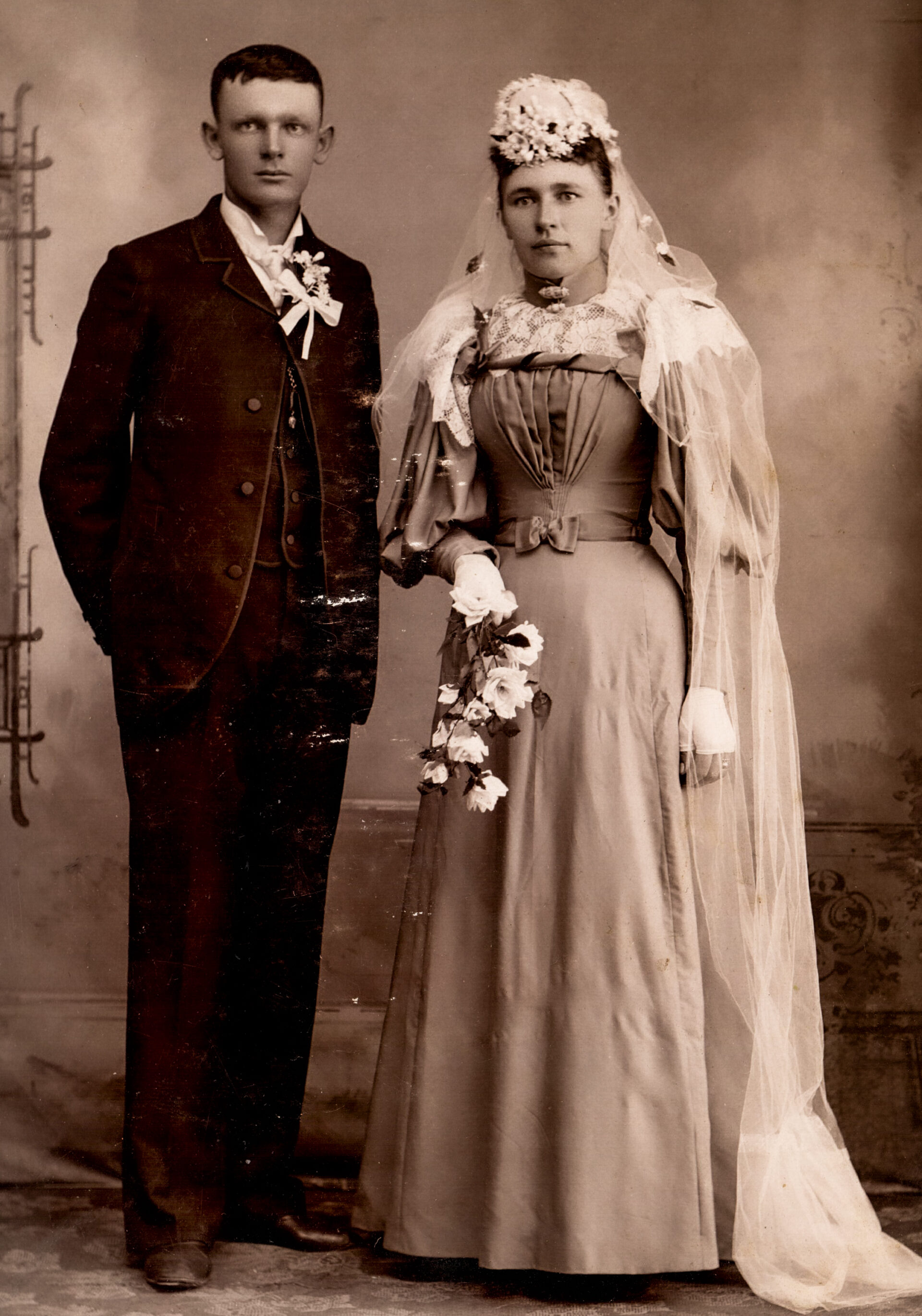 victorian-wedding-portrait-of-a-bride-in-floral-veil-and-groom-in-formal-suit