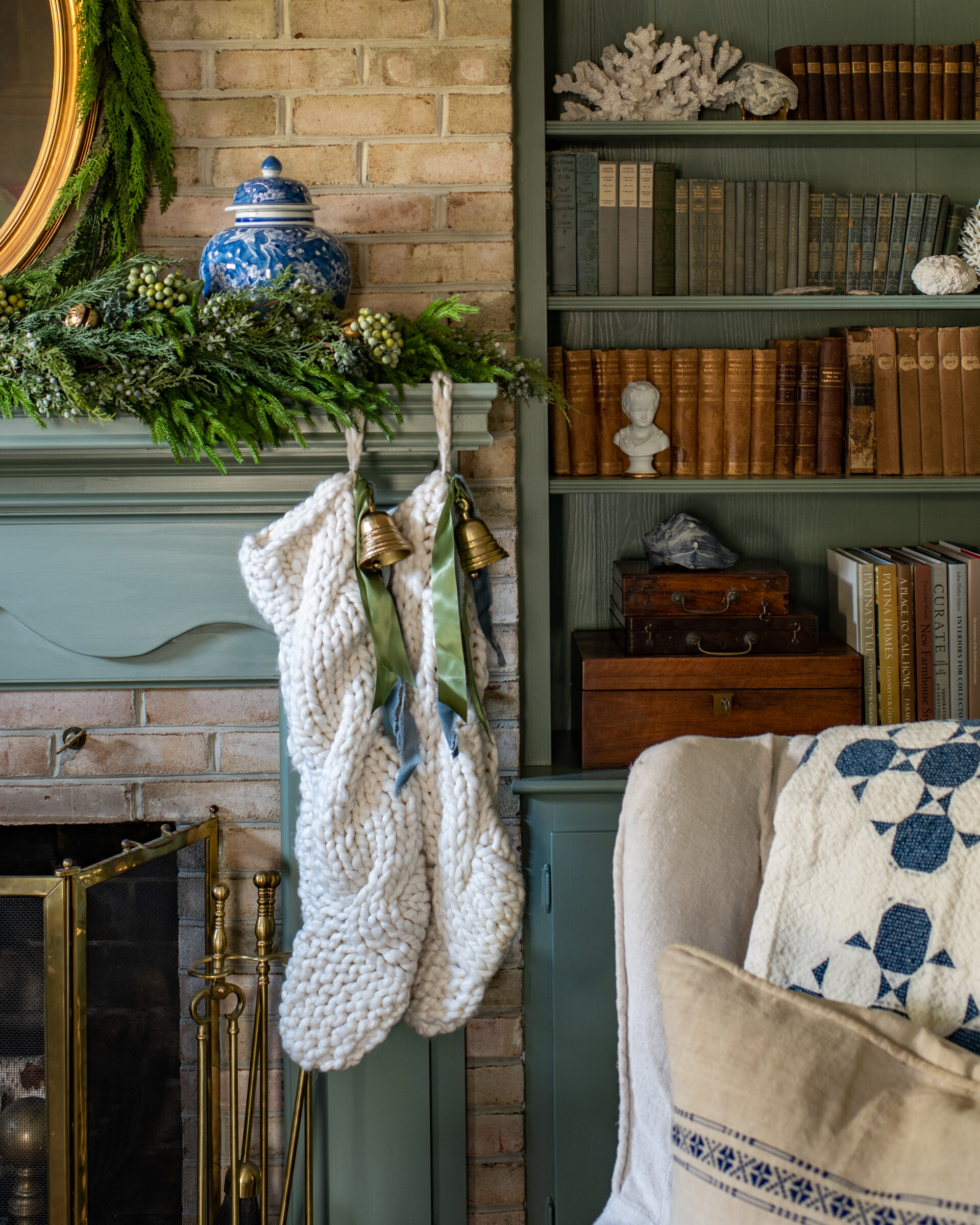 vintage-christmas-fireplace-with-knit-stockings-and-festive-greenery-decor