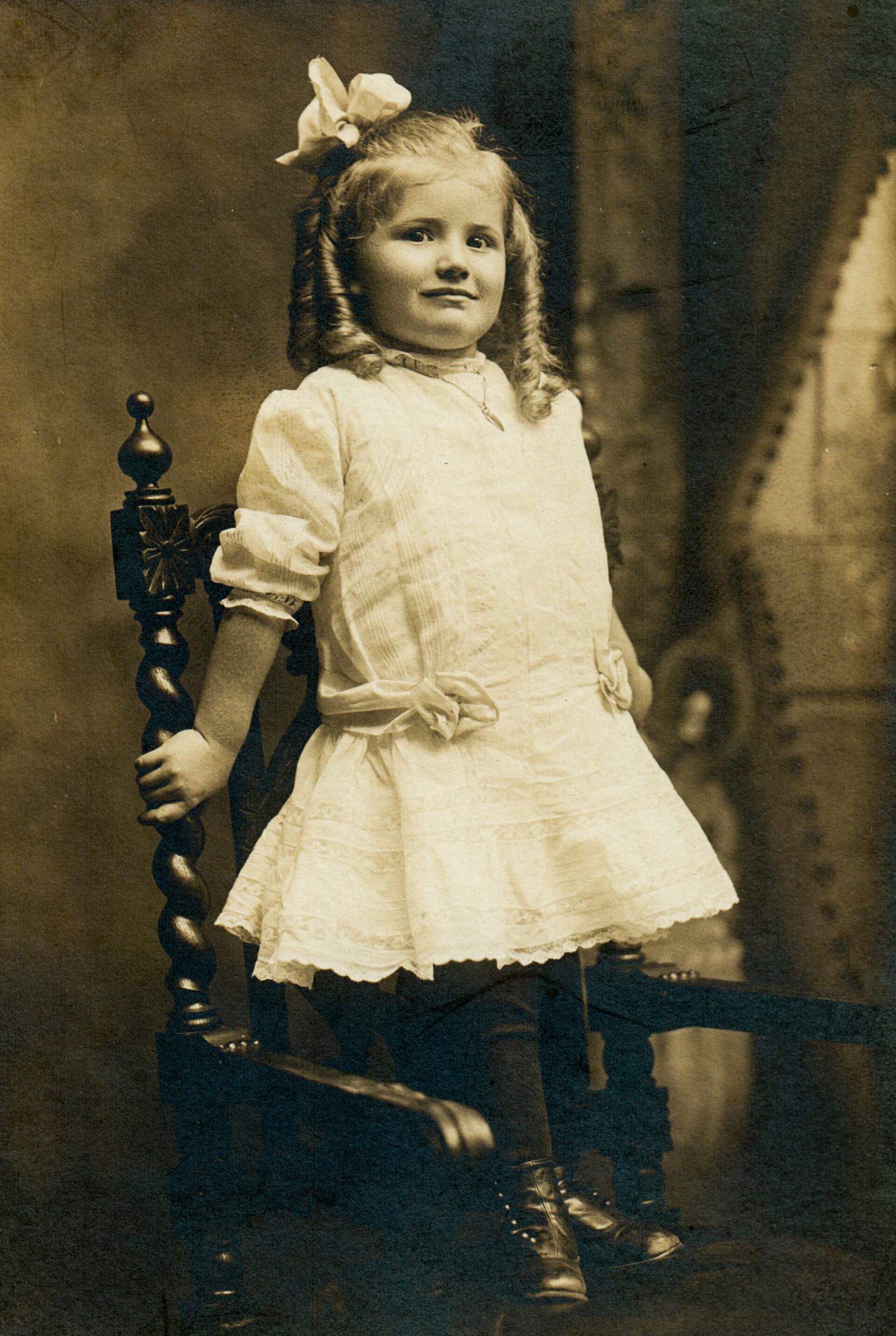 portrait-of-girl-white-dress-large-hair-bow-ringlets