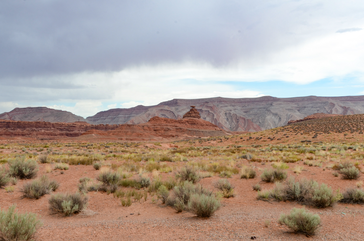 mexican-hat-rock-formation-surrounded-by-utahs-rugged-desert-terrain