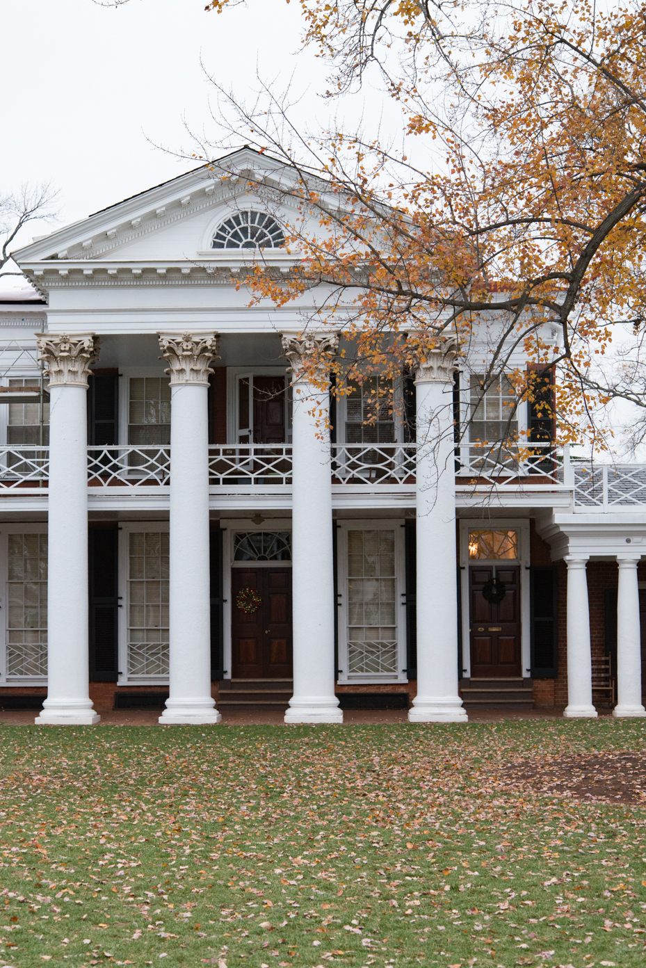 neoclassical-design-with-corinthian-columns-two-story-white-portico-and-fall-foliage