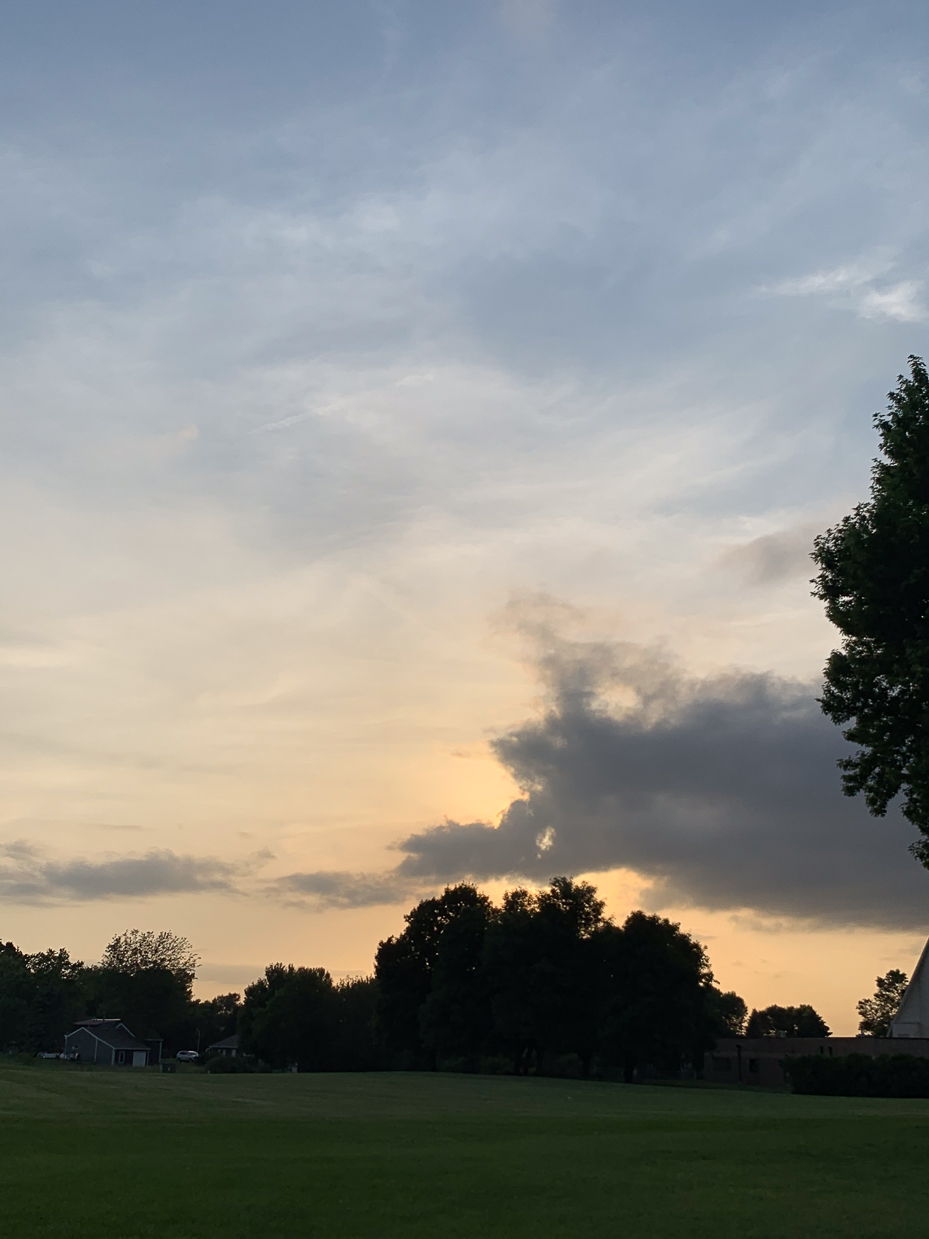 quiet-evening-landscape-with-soft-sunset-glow-and-silhouetted-trees-peaceful-countryside-scene