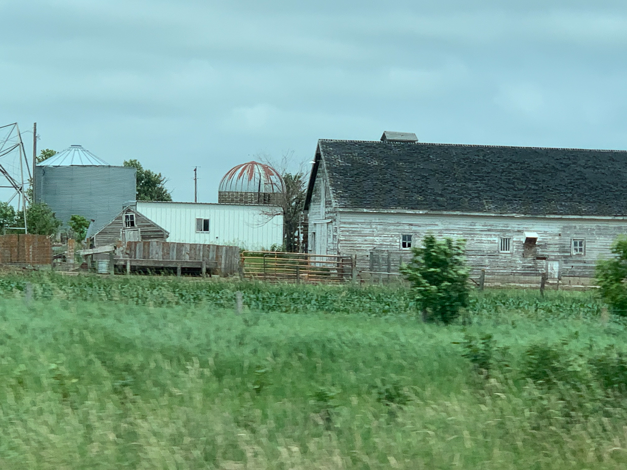 rustic-farmstead-with-weathered-barns-and-silos-in-a-lush-green-landscape-rural-charm