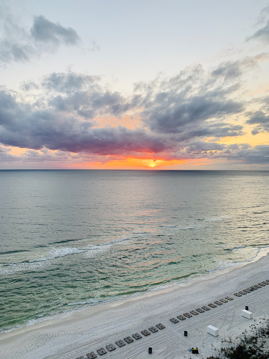 stunning-beach-sunset-with-vibrant-clouds-and-serene-waves-coastal-evening-scene