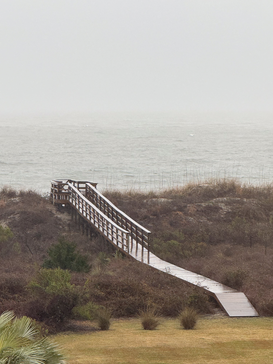 foggy-beach-access-boardwalk-with-ocean-view-and-coastal-vegetation