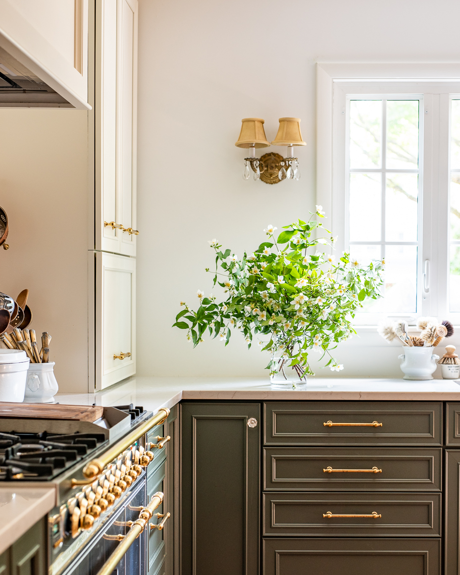 elegant-french-country-kitchen-with-green-cabinetry-and-jasmine-flower-arrangement-artist-reference-photo