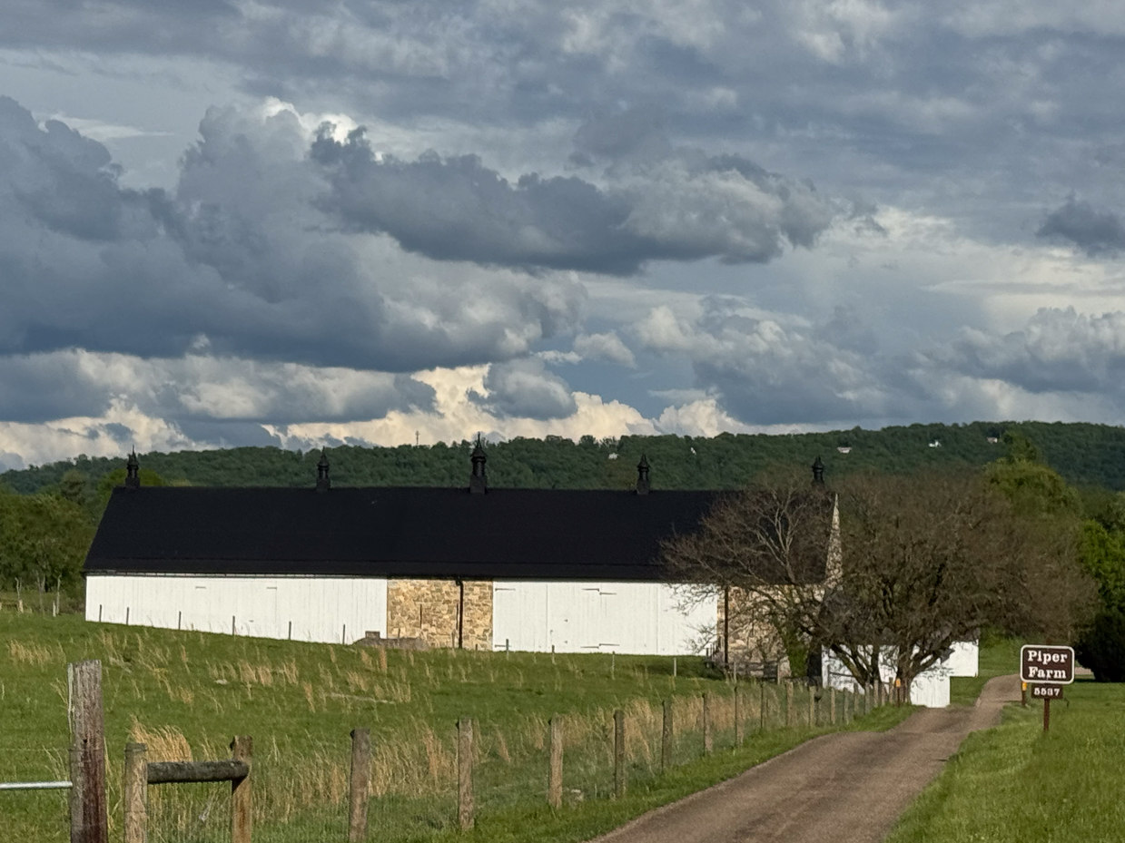 long-driveway-to-white-barn-at-piper-farm-with-rolling-hills-and-storm-clouds-artist-reference-photo