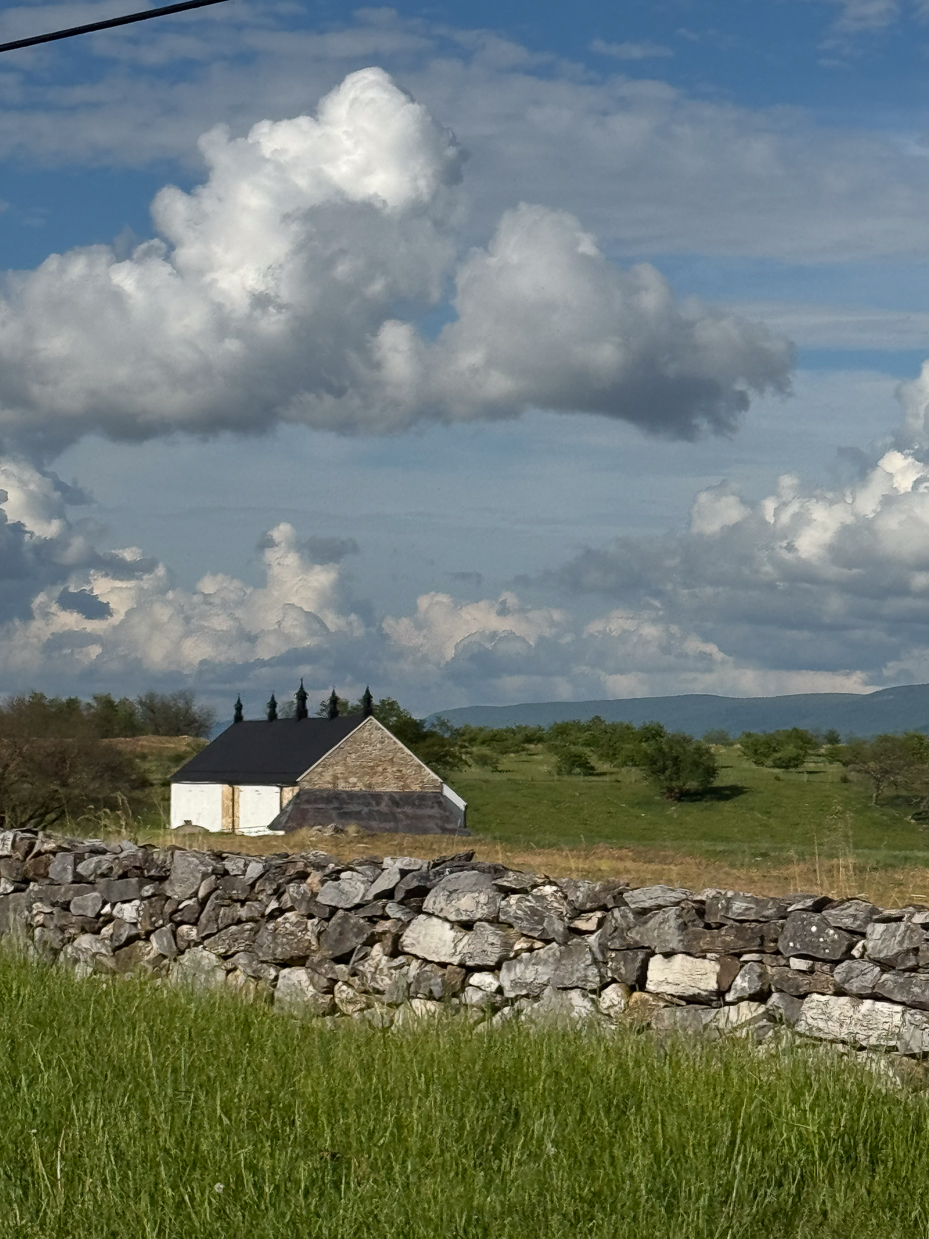 stone-wall-and-farmhouse-under-puffy-cumulus-clouds-artist-reference-photo