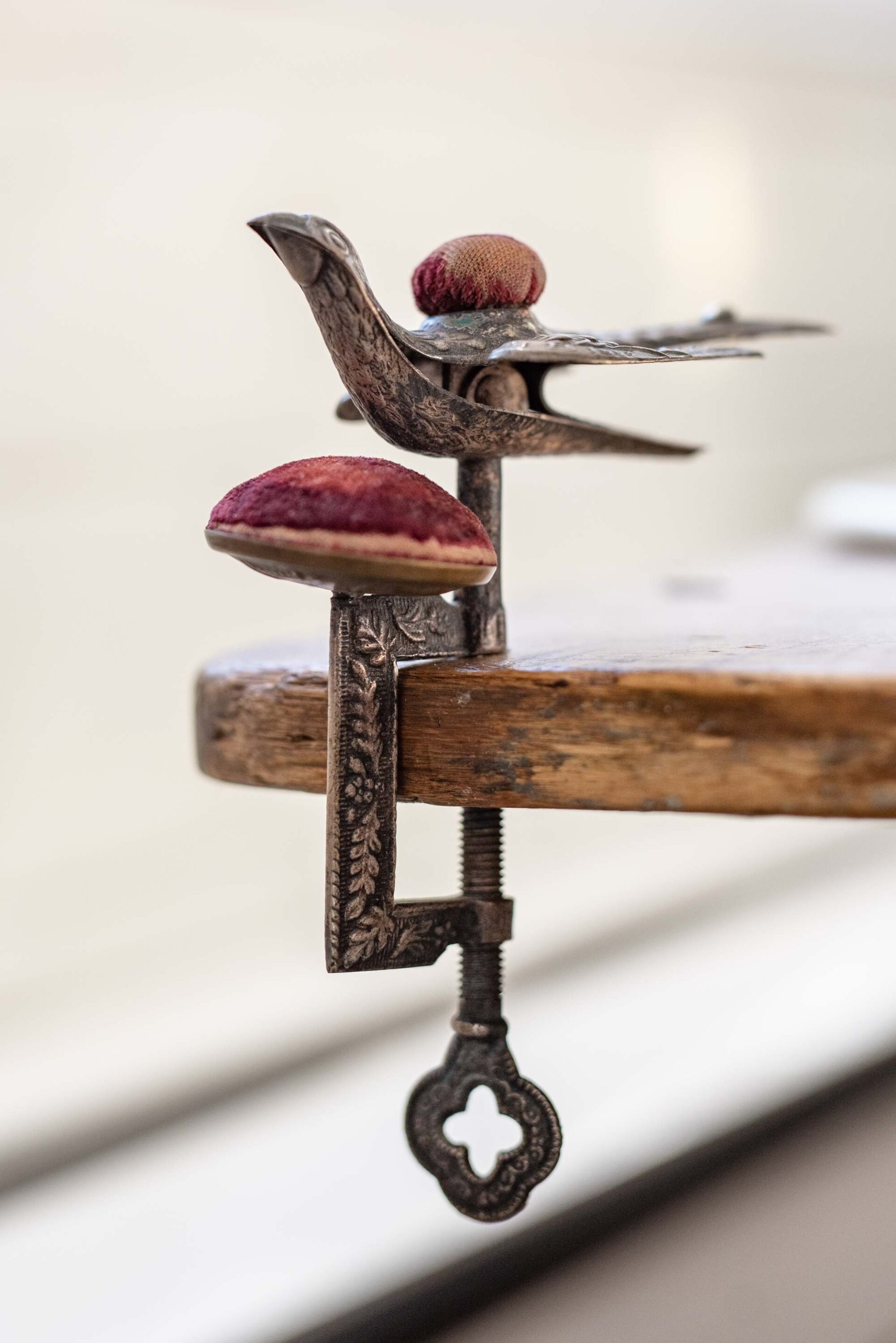 antique-bird-clamp-sewing-tool-with-red-velvet-pincushions-artist-reference-photo