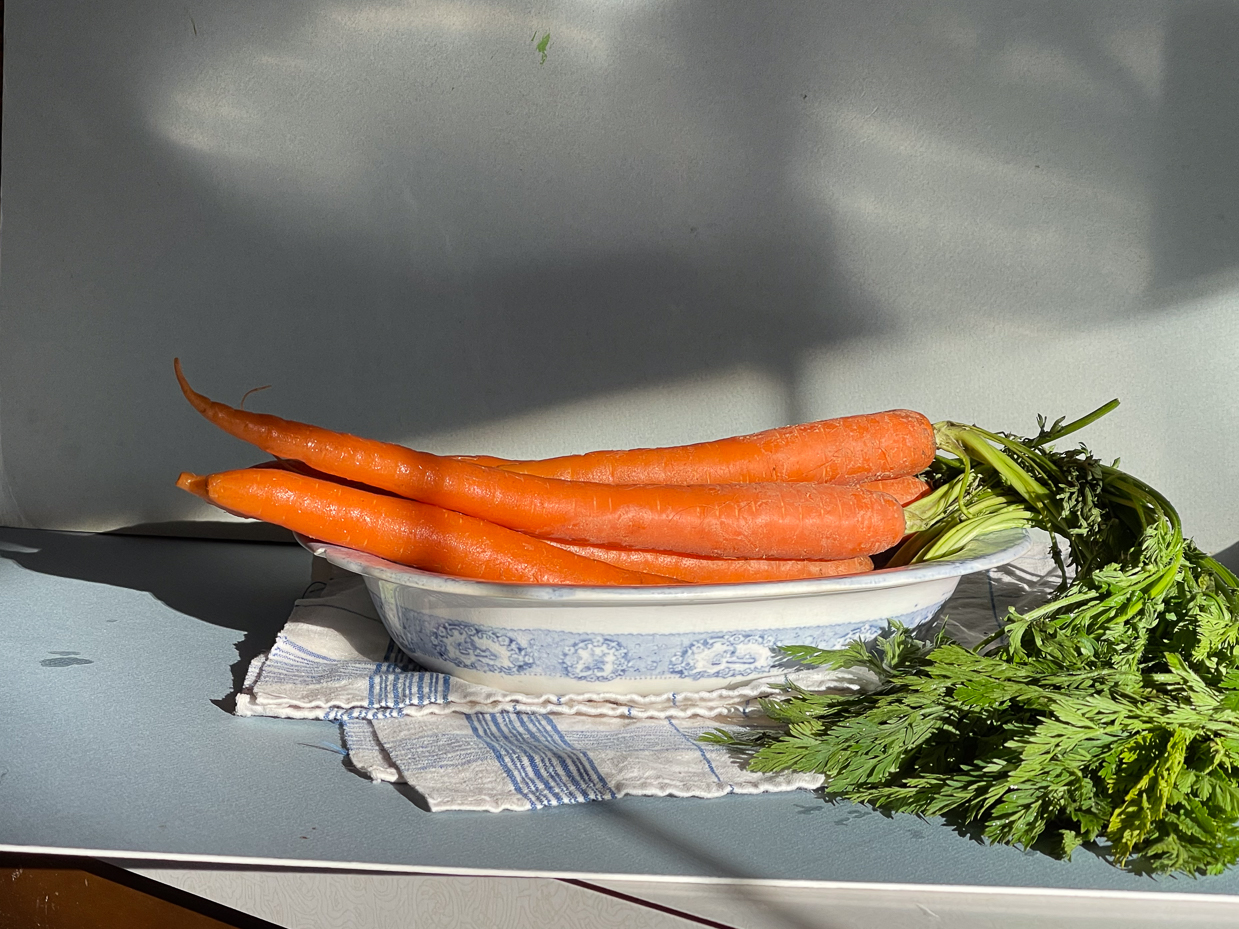 farm-fresh-carrots-with-greens-in-antique-ironstone-bowl-rustic-kitchen-still-life
