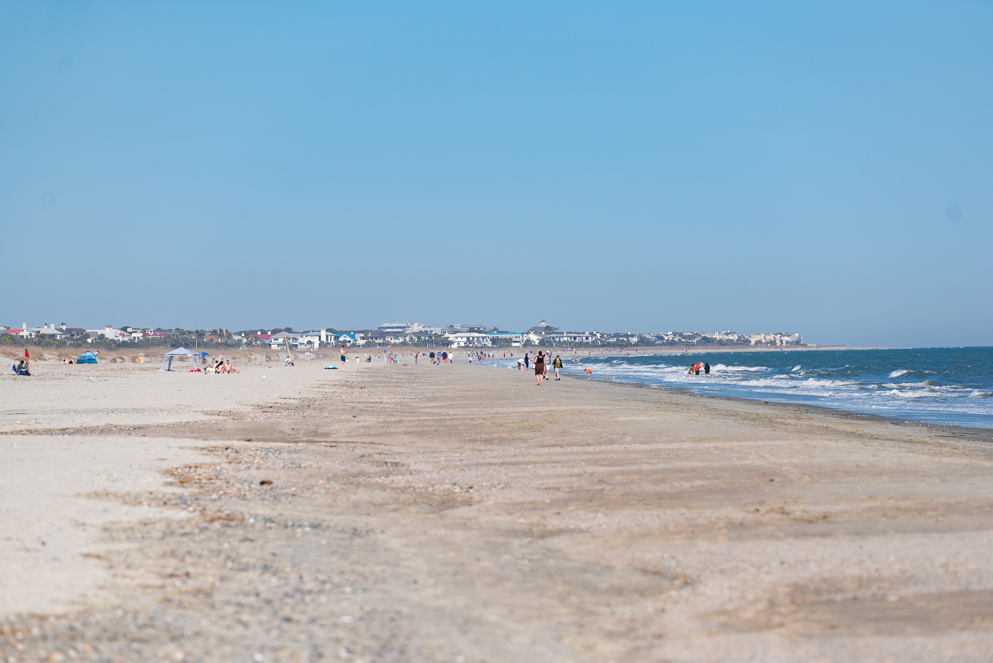 south-carolina-beach-vacation-families-walking-shoreline-oceanfront-homes-summer-day