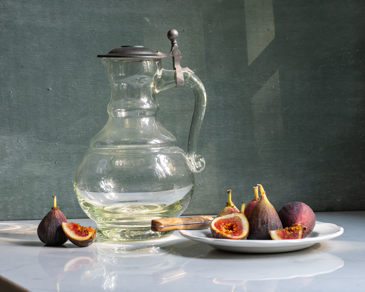 sunlit-glass-pitcher-with-figs-on-ceramic-plate-artist-reference-photo