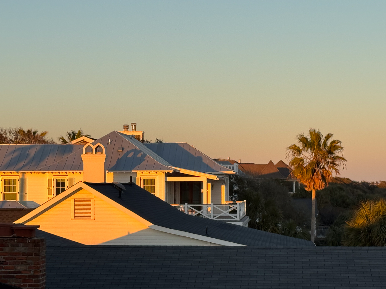 sunrise-light-on-coastal-beach-houses-with-palm-trees-and-clear-sky