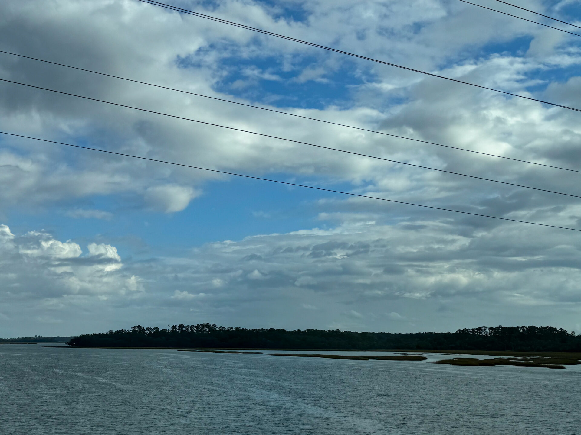 coastal-waterway-with-tree-line-horizon-and-partly-cloudy-sky-artist-reference-photo