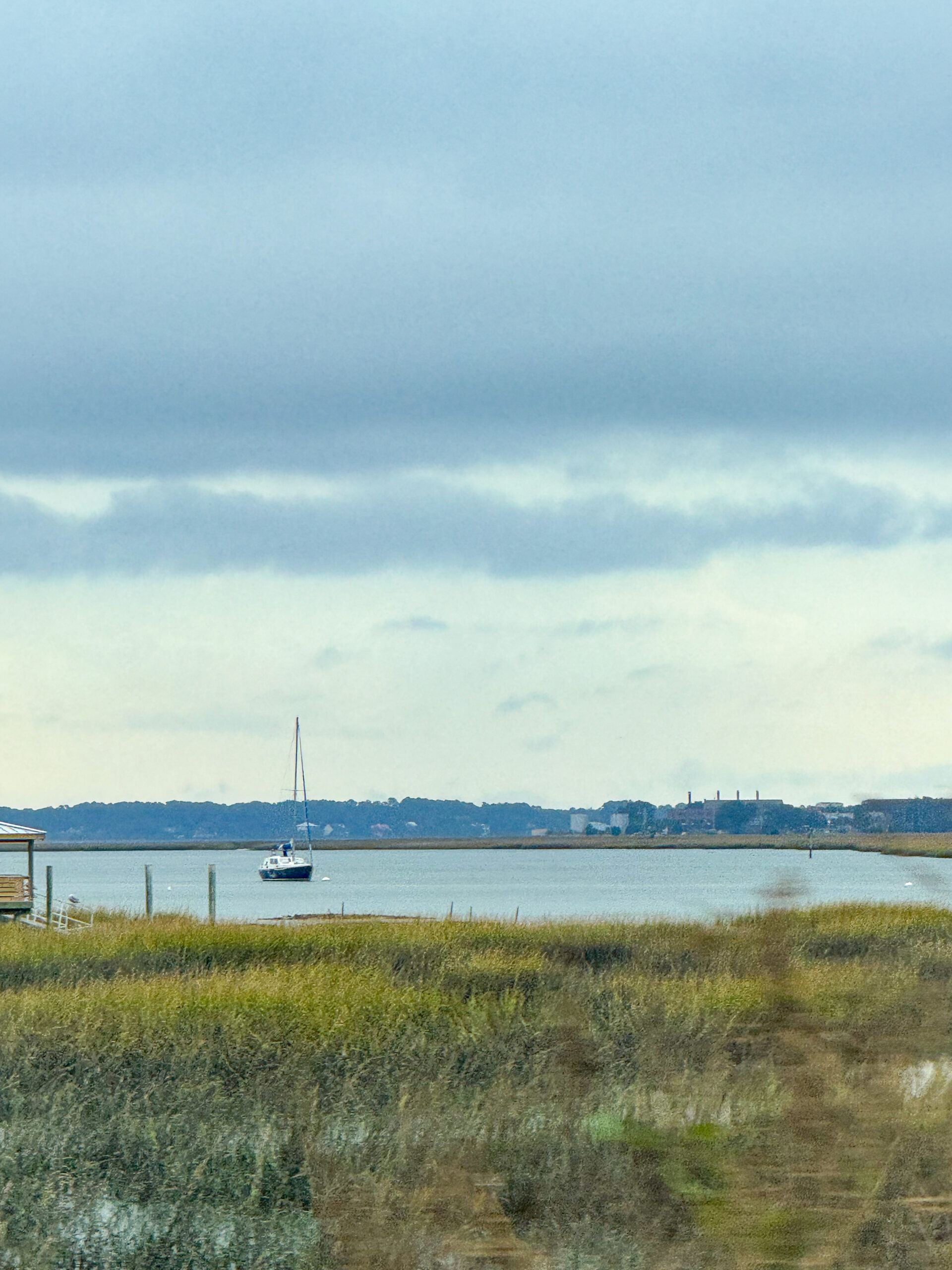 sailboat-on-marshy-bay-with-distant-shoreline-and-overcast-sky-artist-reference-photo