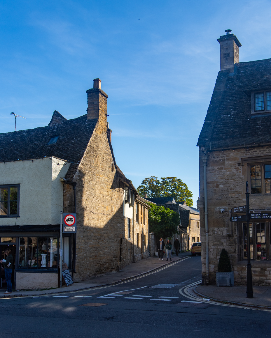 Cotswold street corner with afternoon light and pedestrians artist reference photo artist reference photo