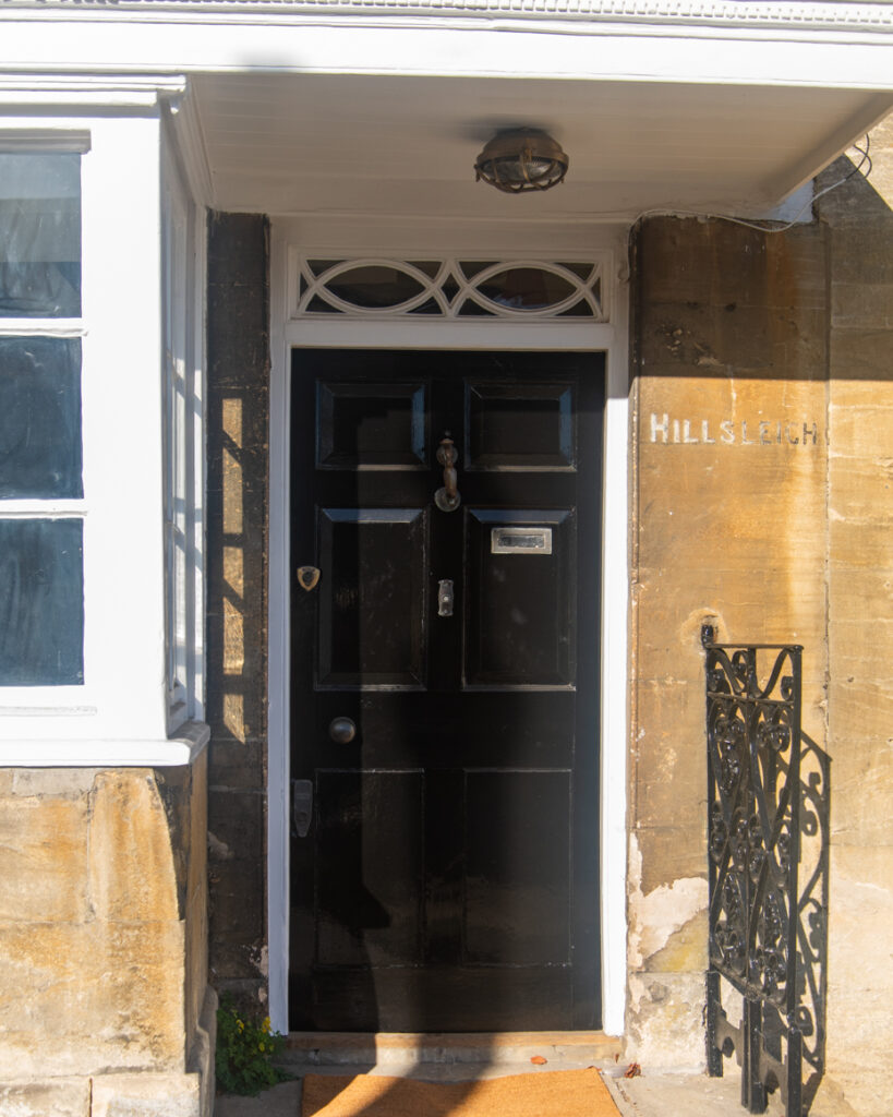 Black door with brass knocker and stone entryway in Cotswolds artist reference photo