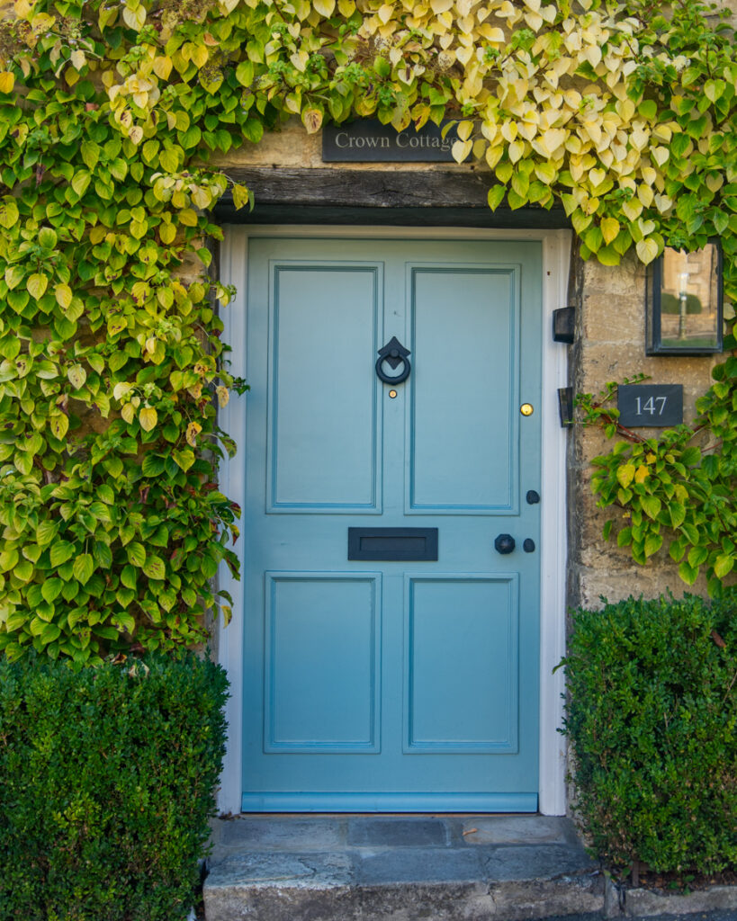 Blue front door framed by ivy at Crown Cottage Burford artist reference photo