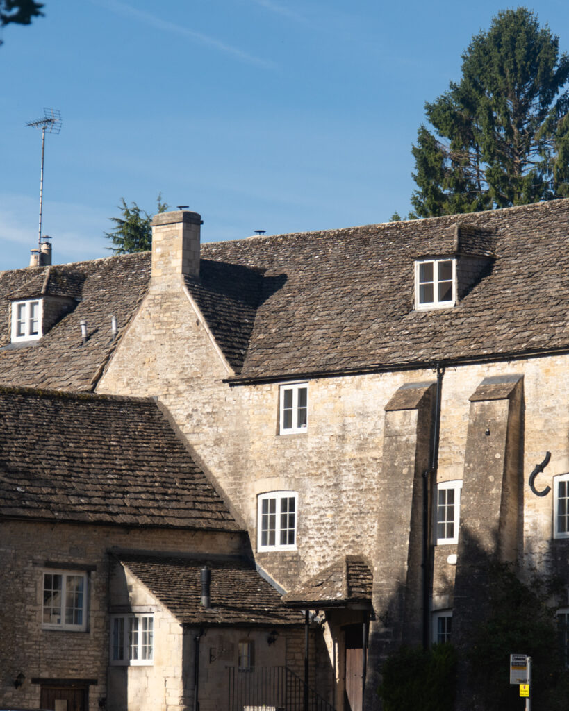 Historic stone mill with tall chimneys and slate roof in Cotswolds artist reference photo