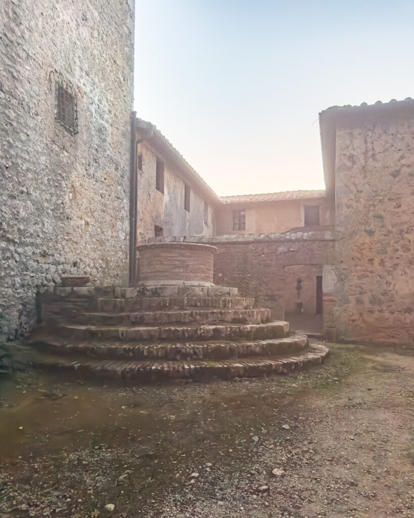 moody stone courtyard and brick well in soft evening light artist reference photo