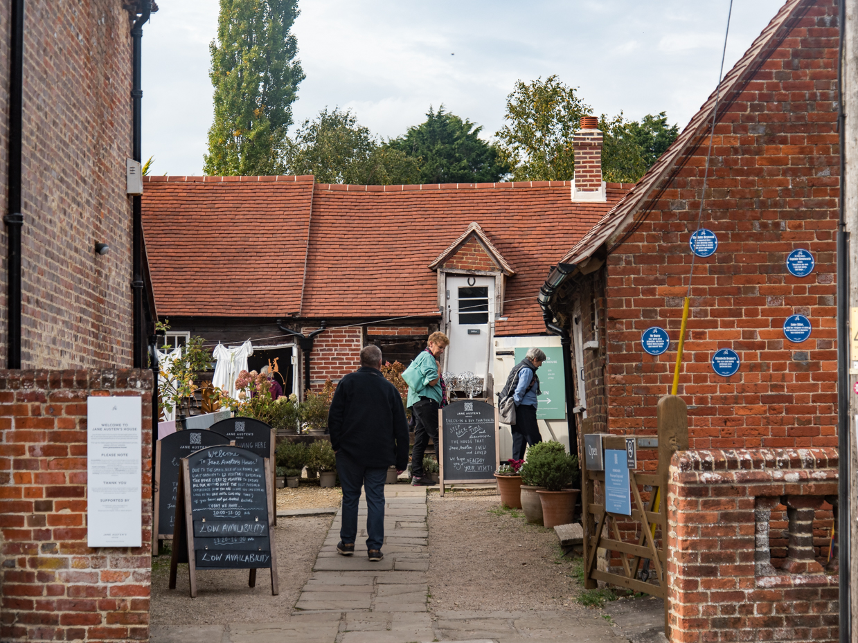 English Courtyard Entrance with Visitors and Brick Buildings artist reference photo