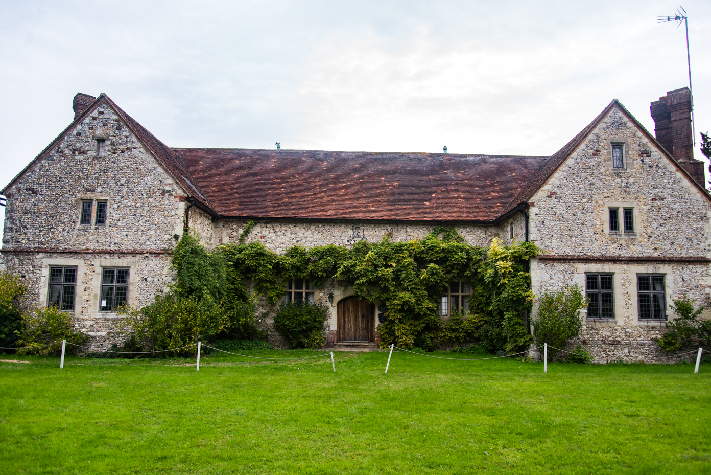 Traditional Tudor Style Stone House with Ivy Covered Facade artist reference photo